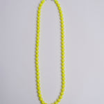 Porta telefono perline rotondo PHONENECKLACE BIG NEONYELLOW ina.seifart 