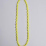 Porta telefono perline rotondo PHONENECKLACE BIG NEONYELLOW ina.seifart 
